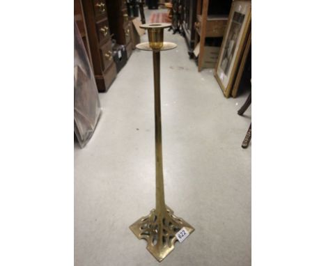 A tall brass arts and crafts candlestick