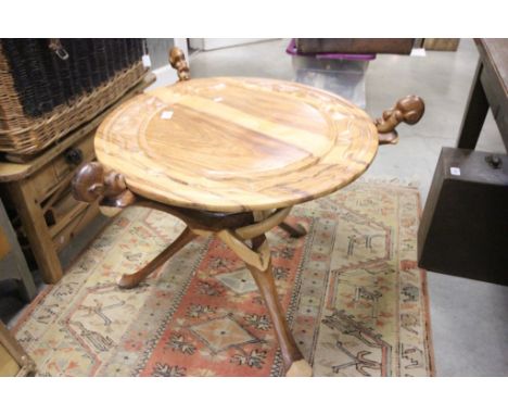 African Hardwood Circualar Table, the folding base carved from a single tree trunk with the tops of the supports in the form 