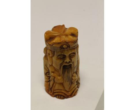 Bone netsuke of a man with gold