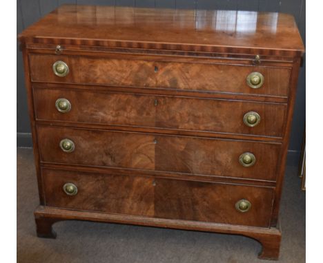 Late Georgian mahogany chest of four graduated drawers with circular embossed brass ring handles beneath a pull out brushing 