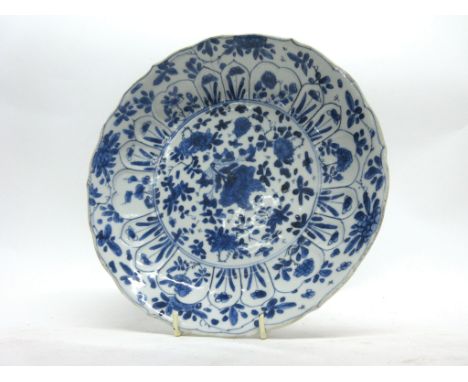 Chinese porcelain plate with a flowering design of plants in Kangxi style, with Kangxi motif to base, 21cm diam