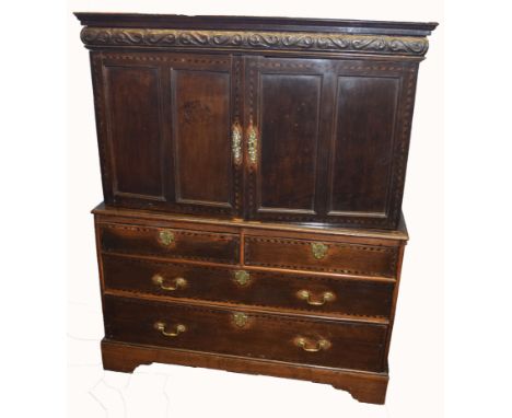 Early 18th century oak cabinet with chest base, having two inlaid double panelled doors beneath a carved frieze, opening to r