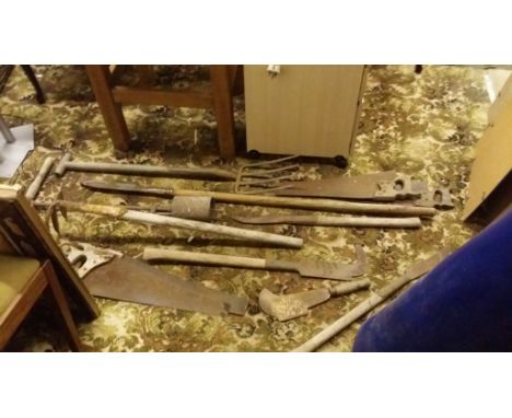 A selection of old gardening tools and cutting implements.