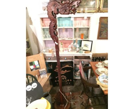 A carved Chinese standard lamp