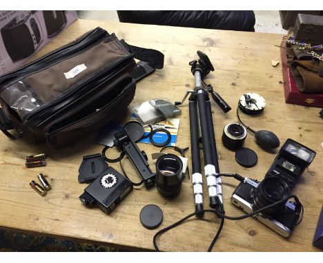 A Praktica slr camera lenses tripod and flash.