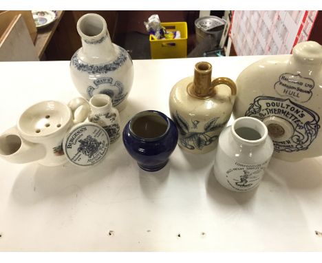A box containing various ceramic pots and a pot lid.