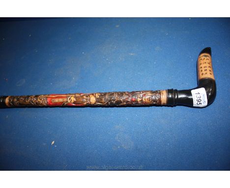 An oriental Walking Stick, profusely decorated with figures, etc.