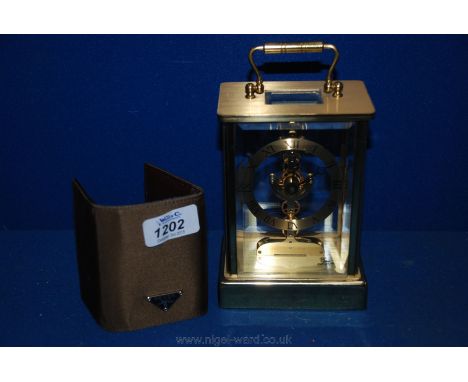 A Prada key holder and a modern brass battery operated Carriage style clock by Emes
