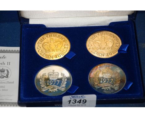 A boxed set of Queen Elizabeth ll 22ct gold plated and sterling silver plated Limited Edition 2002 Coins