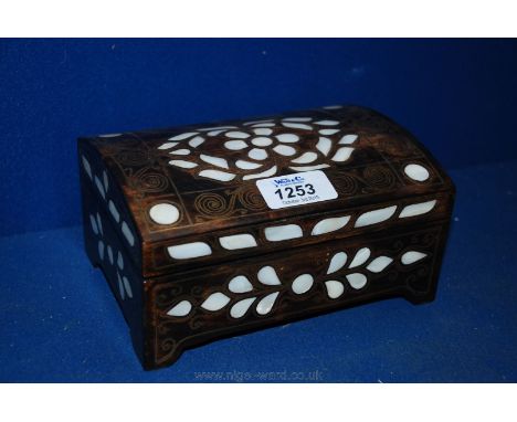 A small wooden box with gold design and mother of pearl inlay.  Red velvet lining.  6 3/4'' x 4 3/4'' x 3 1/2''