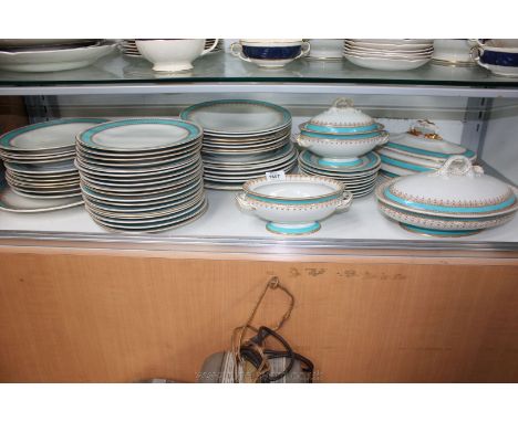 A comprehensive Royal Worcester Dinner service, white ground with turquoise and gold border pattern.