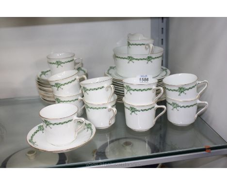 A Tuscan china part Teaset ''Laurel'' pattern in green floral and gilt colours and comprising ten cups,twelve saucers, eleven