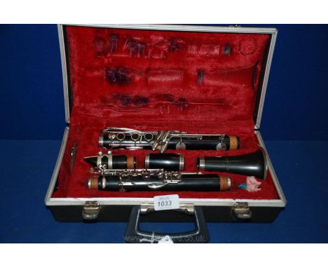 A Clarinet with carrying case, the mouthpiece inscribed 'G LeBlanc Paris' and horn 'Corton'
