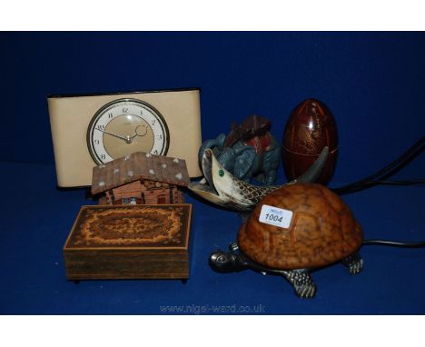 A quantity of miscellanea including a lamp in form of a tortoise, a cast metal elephant, a Ganham mantle clock, fish made out