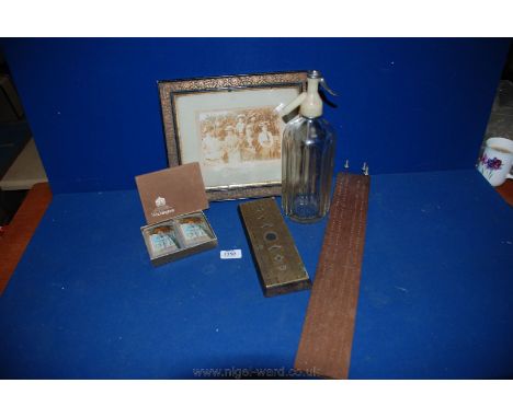 A Soda Syphon by Schweppes Ltd., two cribbage boards, one in wood and one brass, Waddingtons playing cards and an ornate pict