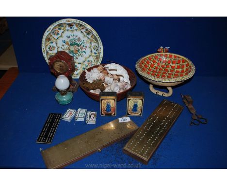 A quantity of miscellanea including shells, three brass cribbage boards, small lamp, three Brass monkeys - see no evil,speak 