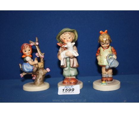 Three Hummel figures including a boy with a lamb (as found), girl in an Apple tree and a little girl with a watering can.