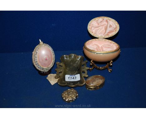 Two hand painted decorative Egg shaped Trinket Boxes, one being pink decorated with small pearls and silver coloured trim, th
