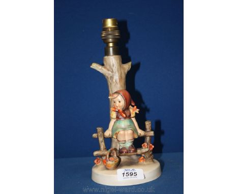 A Goebel table Lamp of a young girl sitting on a fence.  10'' tall