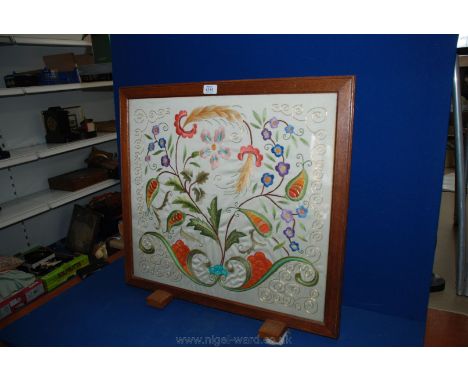 An Oak framed floral woolwork tapestry Firescreen.