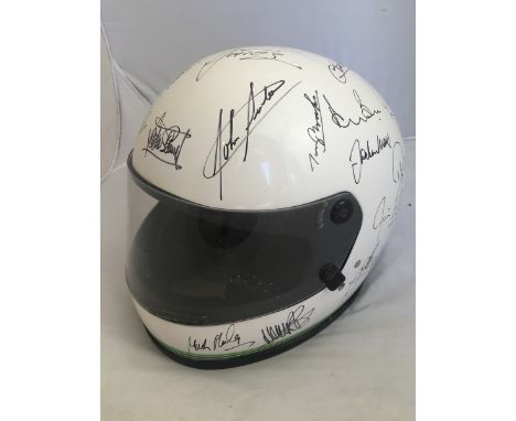 A Centurion Motorcycle helmet covered in signatures by many well known racing drivers including John Surtees, Derek Bell, Jac