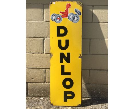 A French Dunlop part pictorial enamel sign depicting a figure poised to drive a car, 12 x 38 1/2".