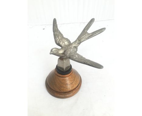 A Swallow nickel plated car accessory mascot, display base mounted.