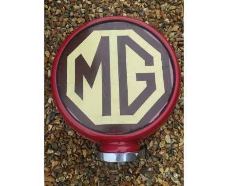 An American petrol pump globe with metal frame and applied MG emblem to both sides, by repute this came from a garage in the 