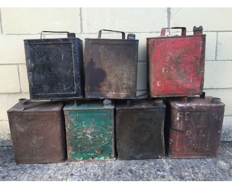 A collection of various petrol cans to include Shell, Esso, W.D 1941 etc.