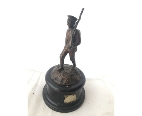 A good quality accessory car mascot in the form of a marching WWI soldier, set on a stylised base, display base mounted.