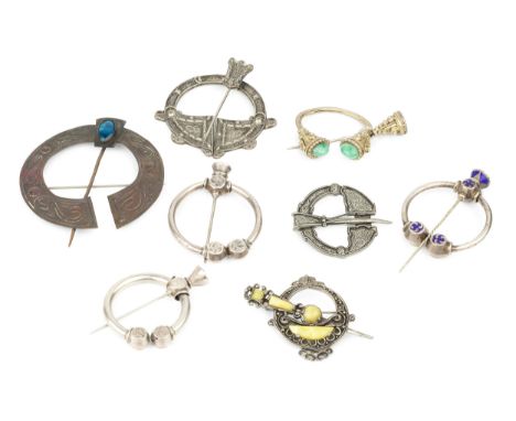 A late Victorian Celtic design cloak pin, with blue enamel decoration, 5cm wide, two similar white metal examples, and five o