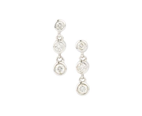 A pair of 18ct white gold and diamond earrings, each with three collet-set brilliant cut stones suspended from the post fitti