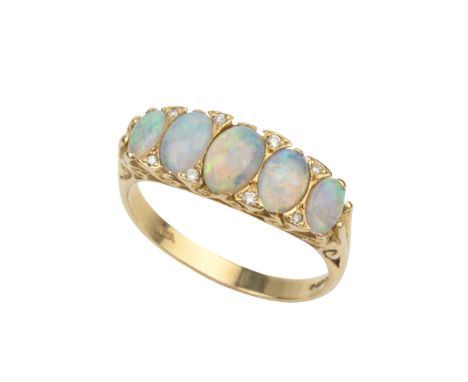 An opal five stone ring, the graduated cabochon opals with diamond points between in scroll pierced 18ct yellow gold mount