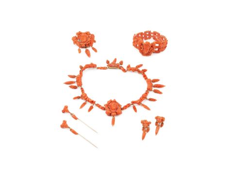 A suite of carved coral jewellery, comprising a necklace, bracelet, brooch, pair of earrings and two stick pins, all carved w