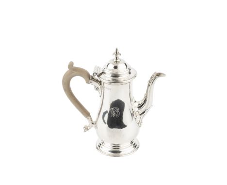 A silver bachelor's coffee pot, of baluster form, with hinged domed cover, scroll and leaf capped spout, and composite handle