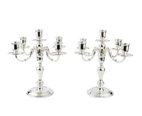 A pair of silver four branch five-light candelabra, the baluster columns having detachable pairs of scrolling branches, so ad