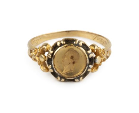 A 19th century gold memorial ring, having glazed relief portrait, possibly depicting the Duke of Wellington, with laurel wrea