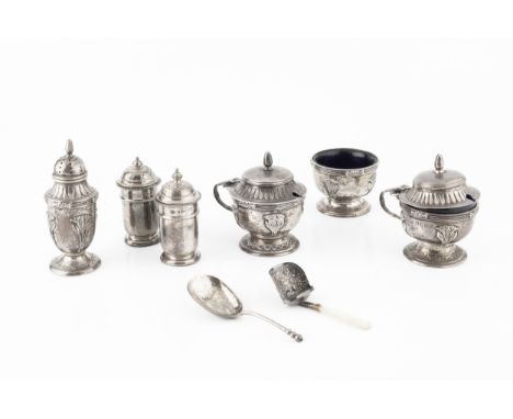 A George V silver three piece cruet set, relief decorated with stylised foliage and having reeded borders by Docker &amp; Bur