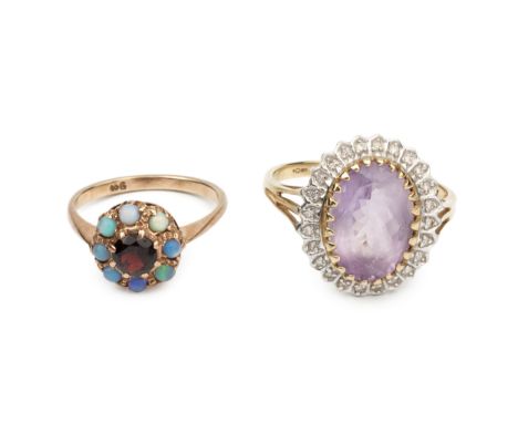 A 9ct gold, garnet and opal cluster ring, and a 9ct gold, amethyst and diamond cluster ring, the oval cut stone within a bord