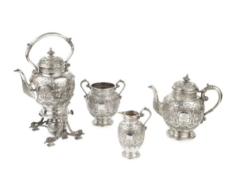 A late Victorian Scottish silver four piece tea service, embossed and chased with classical figures within arched reserves, w