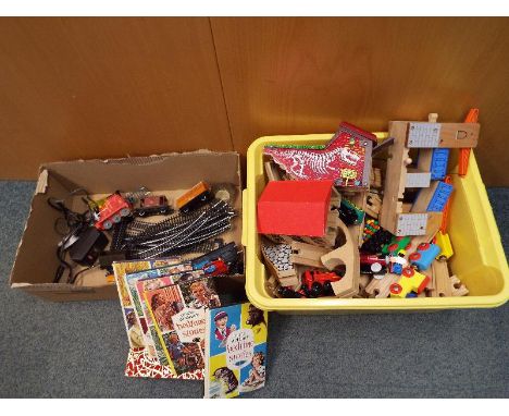 Two boxes containing a collection of track, bridges and trains to include a wooden push-along set and a Thomas the Tank Engin