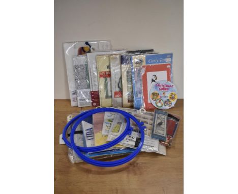 A bundle of vintage cross-stitch paraphernalia, including backing fabric, 9.5' diameter hoop, a colourful range of cotton thr