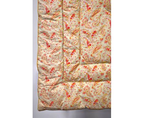 A beautiful Eiderdown quilt, pale yellow-green with pink and red floral paisley pattern, having central quilted flower shape 