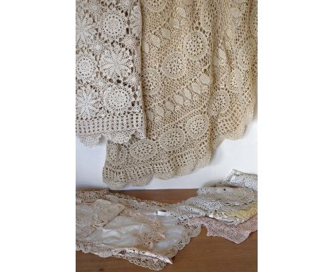 A collection of 20th century crochet, cotton and lace tableware in shades beige, off-white and blush pink. A circular crochet