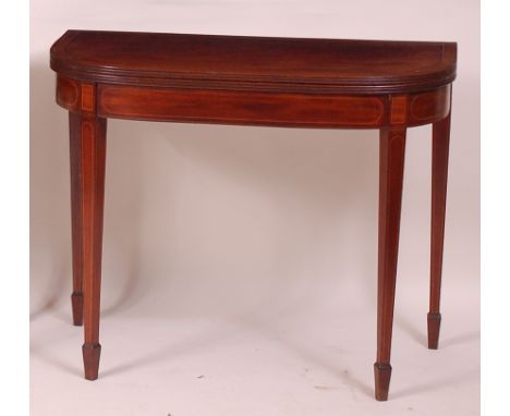 A late Georgian mahogany and satinwood strung D-shaped card table, the fold-over top having a reeded edge and opening to reve