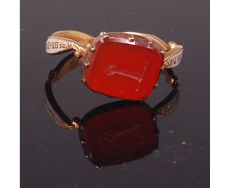 A George II yellow metal agate and enamel mourning ring, the agate seal with finely engraved armorial, the band inscribed 'WM