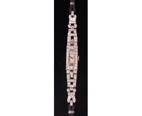 A ladies Art Deco white metal and diamond set cocktail watch, having manual wind movement, the case set with brilliant and ba