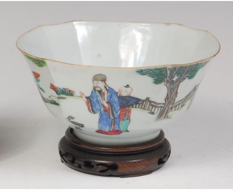 A 19th century Chinese porcelain bowl, enamel decorated with figure scenes within a landscape, square seal mark verso, raised