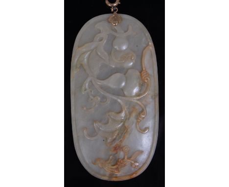 A large 19th century Chinese carved and polished celadon jade pendant, of oval form, with floral relief decoration and raised