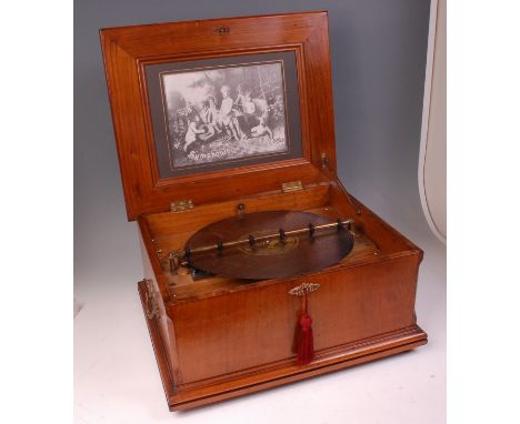 A late 19th century walnut cased table-top polyphon, playing 13.5" discs, the case with brass carry handles and crank handle,